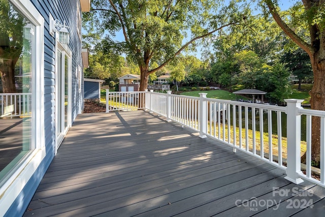 deck featuring a lawn and a gazebo