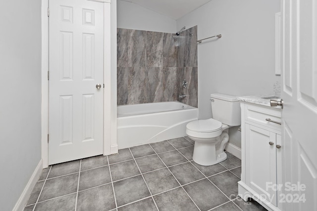 full bathroom with tile patterned flooring, toilet, tiled shower / bath combo, and vanity