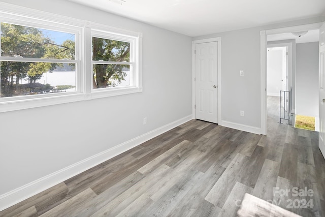 unfurnished bedroom with baseboards and wood finished floors