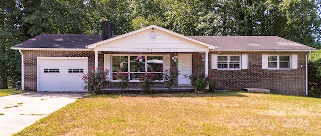 ranch-style house with a front yard and a garage