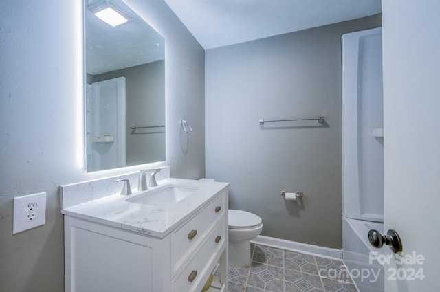 bathroom with vanity, toilet, and tile patterned flooring