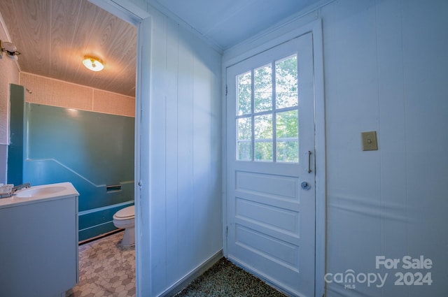 doorway to outside with wooden ceiling and sink