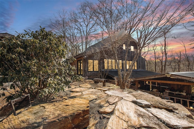 back house at dusk with a patio