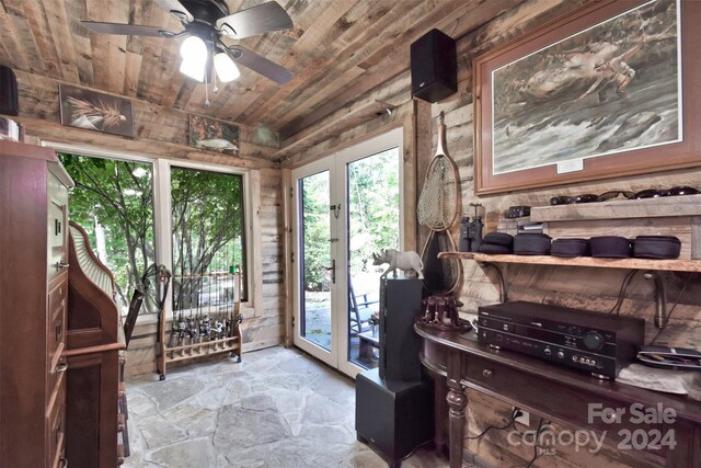 interior space with ceiling fan and wood ceiling