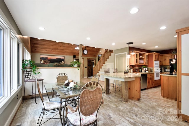 dining space with wooden walls and sink