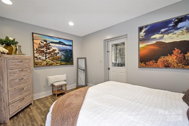 bedroom with dark hardwood / wood-style flooring