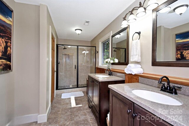 bathroom featuring vanity and a shower with shower door