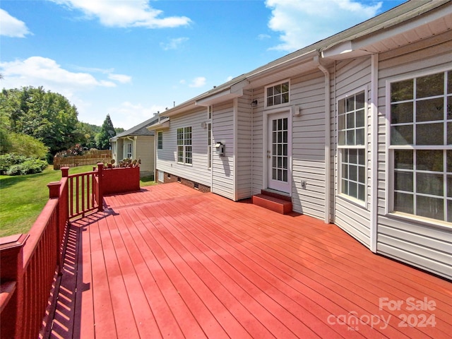 wooden deck with a lawn and fence