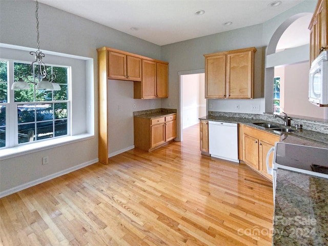 kitchen featuring light hardwood / wood-style flooring, a healthy amount of sunlight, and white appliances