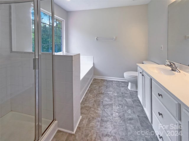 full bathroom with a stall shower, baseboards, toilet, a garden tub, and vanity