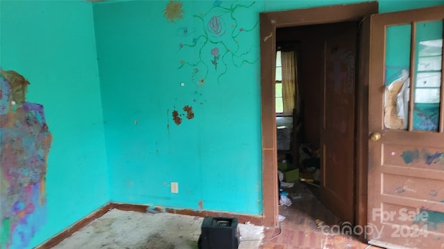 spare room featuring baseboards