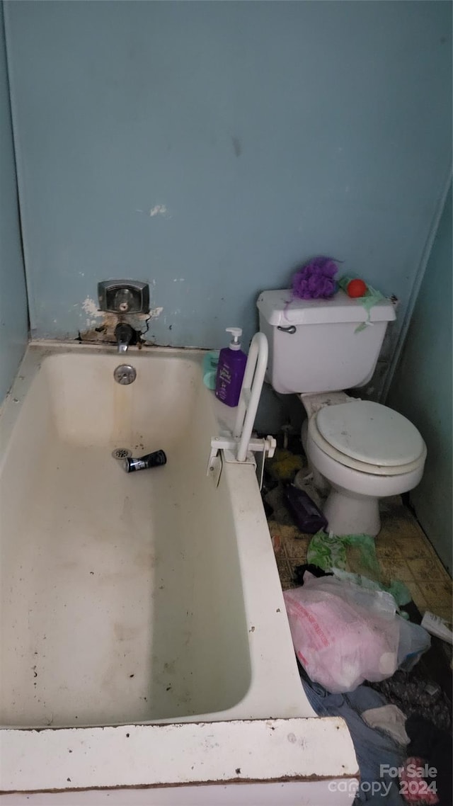 full bathroom featuring toilet and a bath