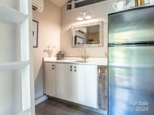 bathroom with vanity, hardwood / wood-style floors, and an AC wall unit