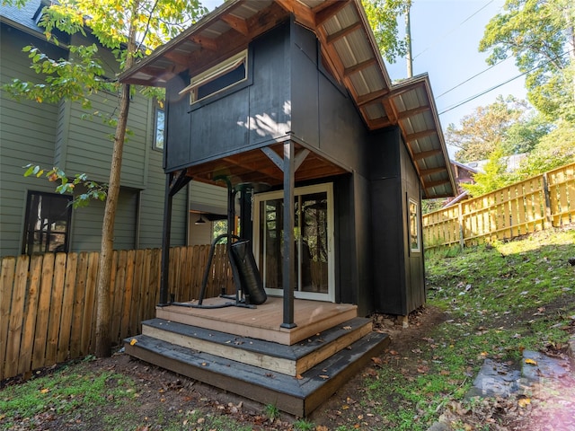 rear view of property featuring a wooden deck