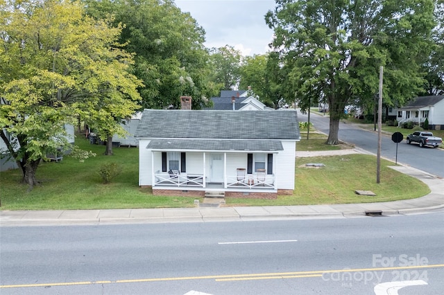 view of front of home with a front lawn and a porch