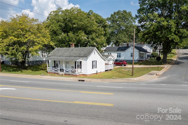 view of front of home with a front lawn and a porch