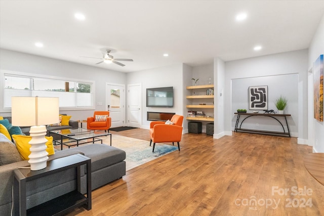 living room with ceiling fan and hardwood / wood-style floors