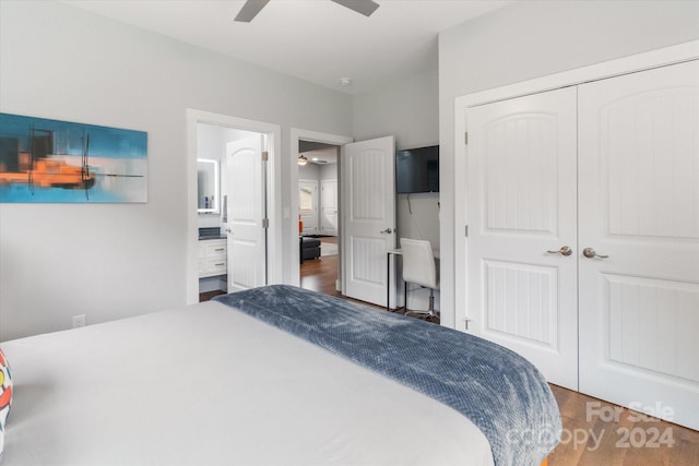 bedroom with ceiling fan, a closet, wood-type flooring, and ensuite bathroom