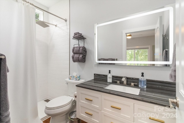 bathroom featuring curtained shower, toilet, and vanity