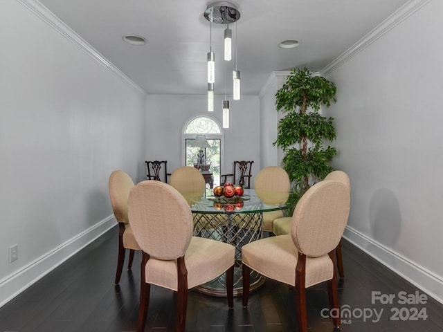 dining space with crown molding and dark hardwood / wood-style flooring