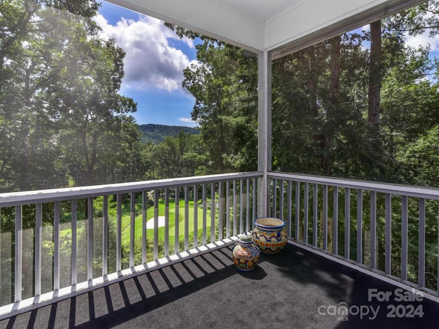 balcony featuring a view of trees