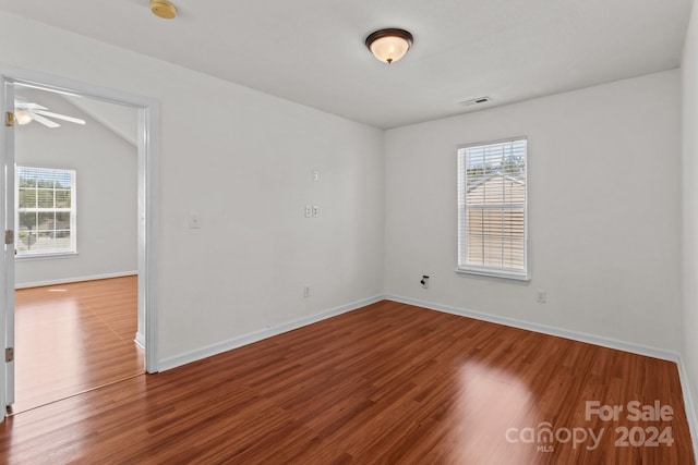 spare room featuring vaulted ceiling, hardwood / wood-style floors, and ceiling fan