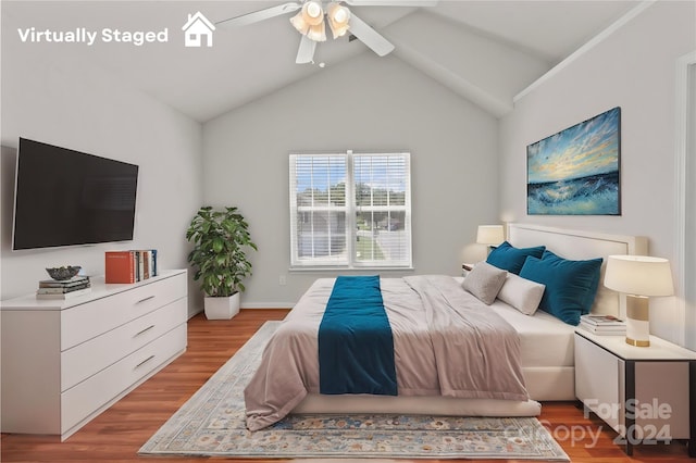 bedroom featuring light wood-type flooring, lofted ceiling, and ceiling fan