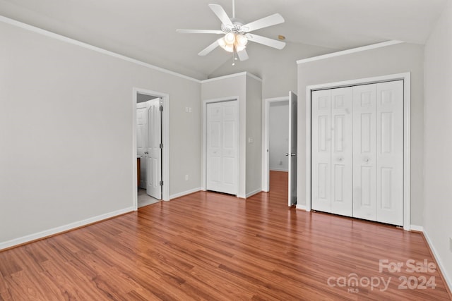 unfurnished bedroom with lofted ceiling, ceiling fan, and wood-type flooring