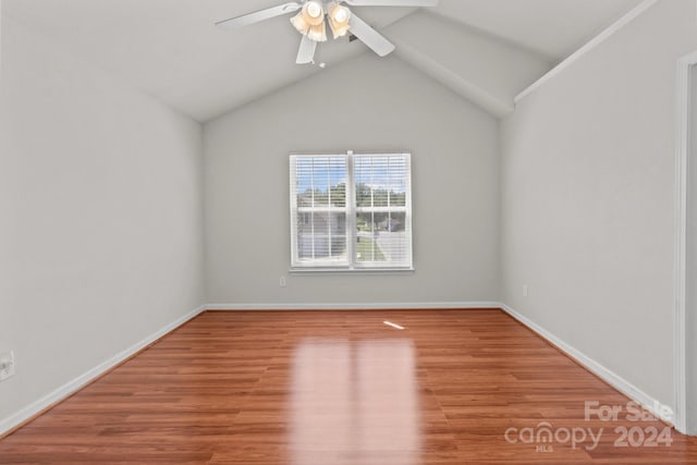 unfurnished room with light hardwood / wood-style flooring, ceiling fan, and vaulted ceiling