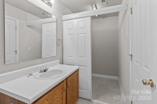 bathroom featuring tile patterned floors and vanity