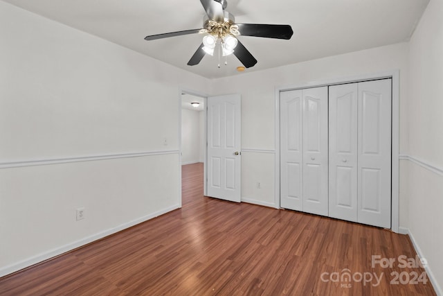 unfurnished bedroom featuring a closet, ceiling fan, and wood-type flooring