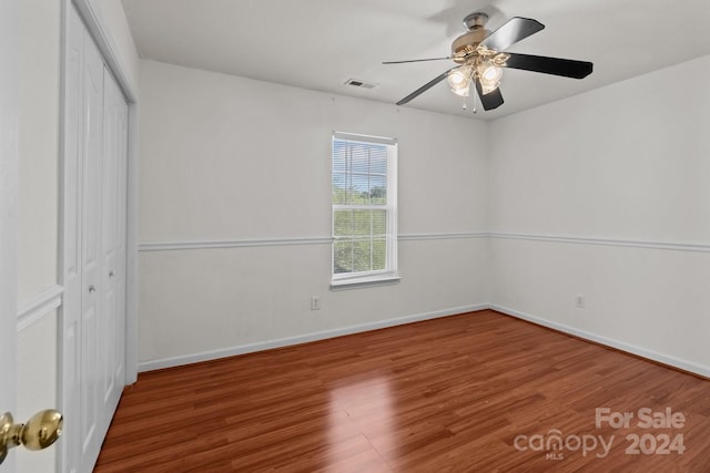 unfurnished bedroom with a closet, ceiling fan, and hardwood / wood-style flooring