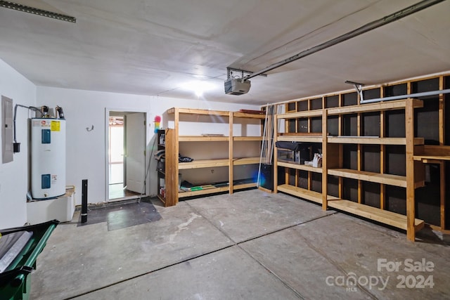 interior space with a garage door opener, water heater, and electric panel