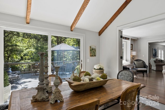 dining area featuring lofted ceiling with beams and hardwood / wood-style floors