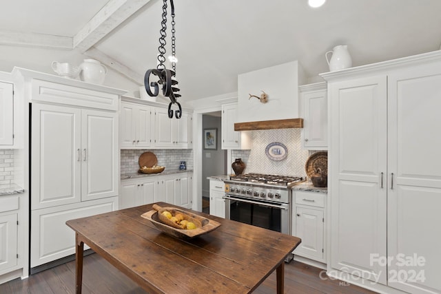 kitchen featuring white cabinets, tasteful backsplash, and high end stainless steel range