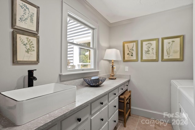 bathroom with separate washer and dryer, vanity, and crown molding