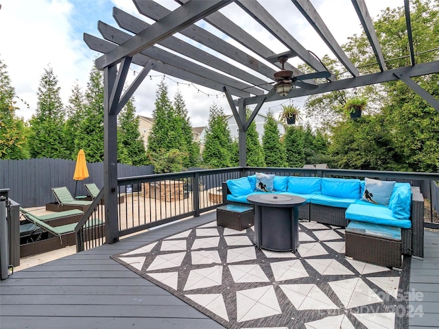 deck featuring an outdoor living space with a fire pit and a pergola