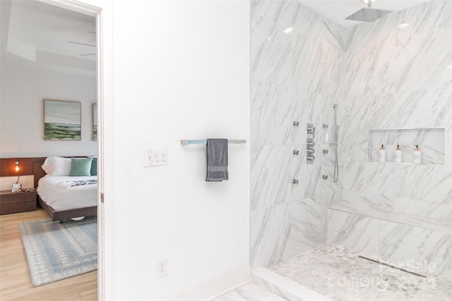 bathroom featuring wood-type flooring and tiled shower