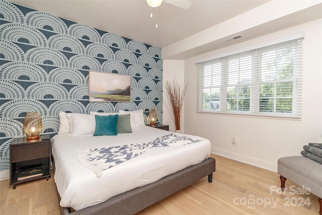 bedroom with ceiling fan and hardwood / wood-style flooring