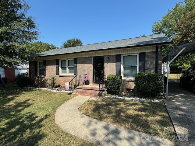 single story home with a front yard and a carport