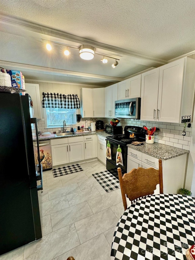 kitchen with black appliances, sink, white cabinetry, and tasteful backsplash