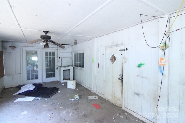 interior space with ceiling fan and french doors