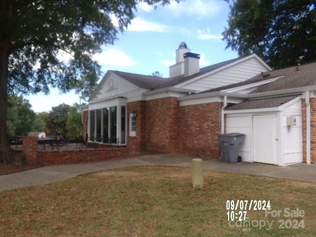 rear view of property featuring a lawn