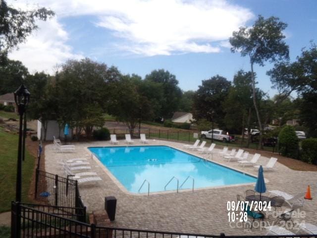 view of swimming pool with a patio area