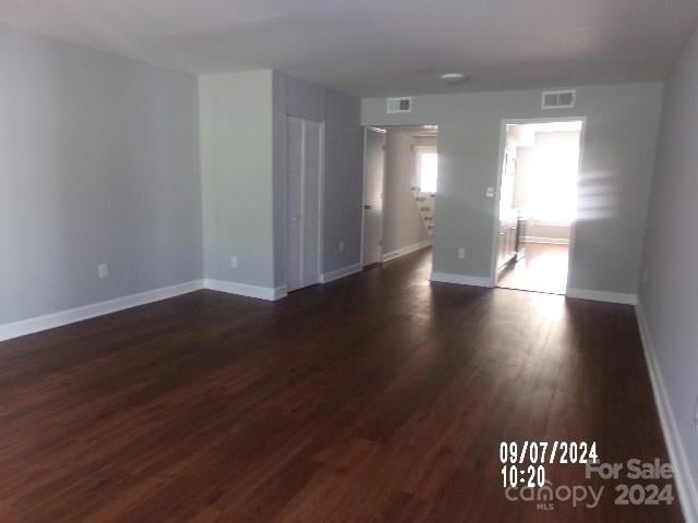 unfurnished room featuring dark wood-type flooring