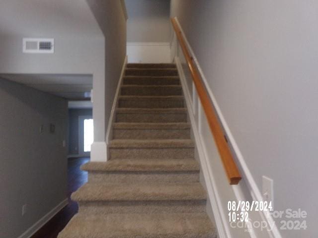 staircase featuring hardwood / wood-style flooring