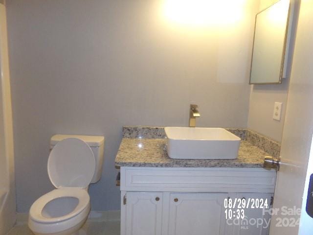 bathroom featuring vanity and toilet