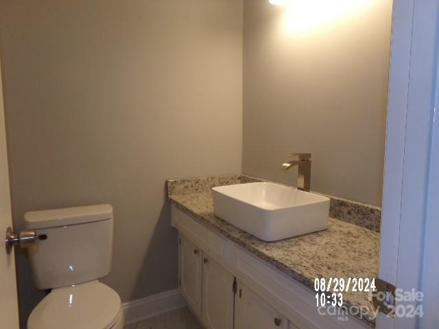 bathroom featuring vanity and toilet