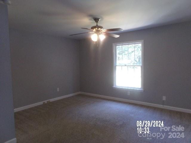 spare room featuring ceiling fan and carpet floors