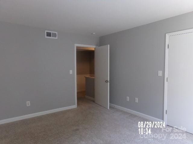 spare room with light colored carpet